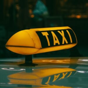 a yellow taxi sign sitting on top of a car